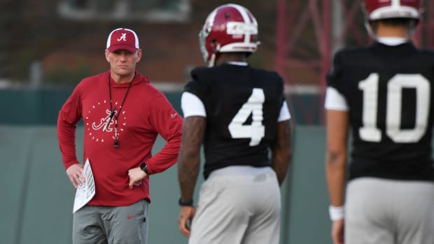 Alabama football coach Kalen DeBoer watches his quarterbacks go through drills during practice in March.