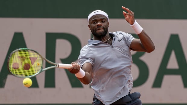 Tiafoe strikes the ball during his match at the French Open.
